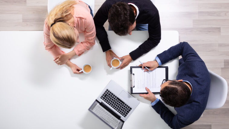 Couple consulting with a debt defense lawyer