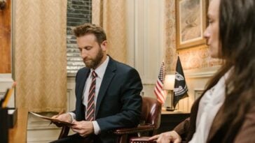 Photo by RDNE Stock project: https://www.pexels.com/photo/a-man-in-a-suit-looking-at-a-document-while-sitting-in-an-armchair-7841474/